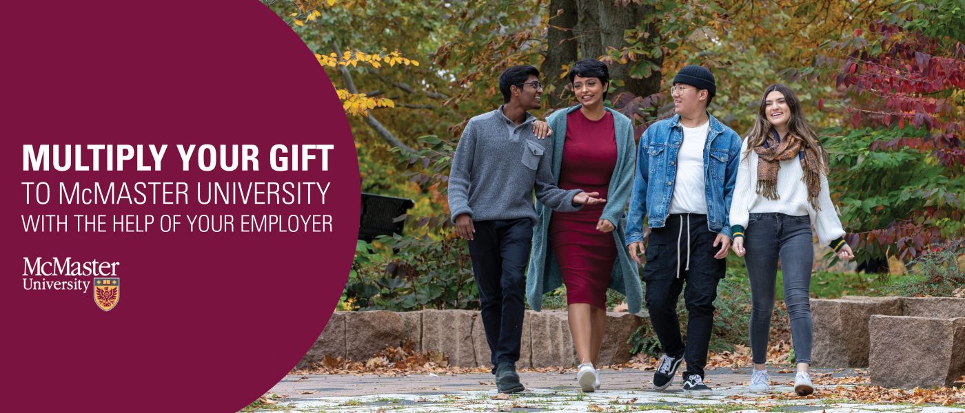 Four students walking on campus with the words Multiply Your Gift